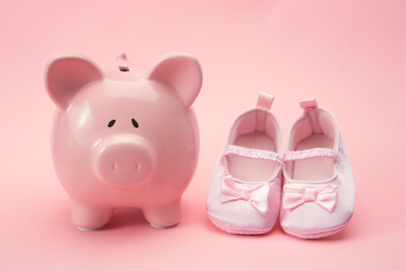 piggy bank next to little ballet slippers